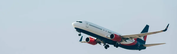 Flight departure of airplane with blue sky at background, panoramic shot — Stock Photo