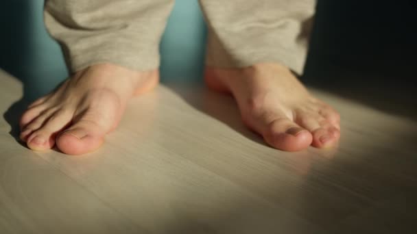 Man Stands Barefoot Light Floor Close Camera Moving — Stock Video