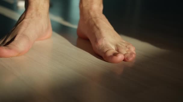 A man stands on the floor with bare feet. — Stock Footage Man Stands Floor Bare Feet Royalty Free Stock Video