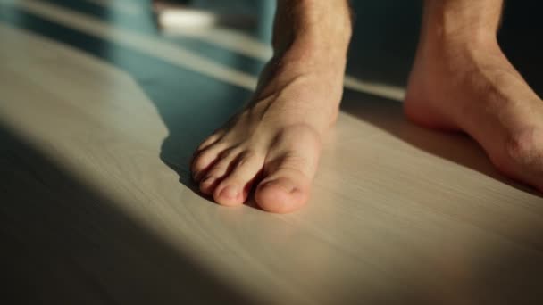 Man stands on the floor with bare feet, camera movement — Stock Footage Man Stands Floor Bare Feet Camera Movement Stock Video