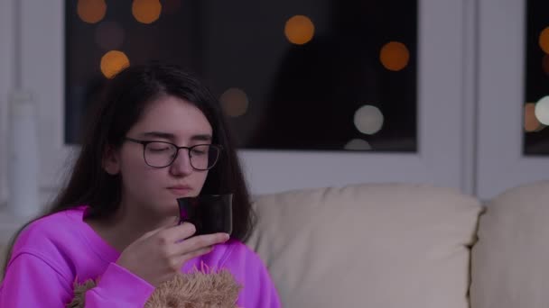 Chica Morena Joven Gafas Bebe Noche Sentado Sofá — Vídeo de stock