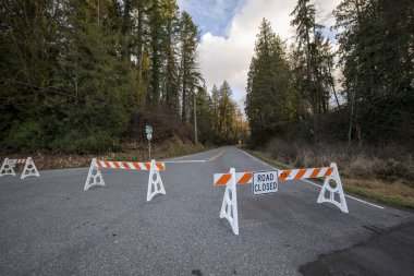 Road closed by barriers blocking access wide angle