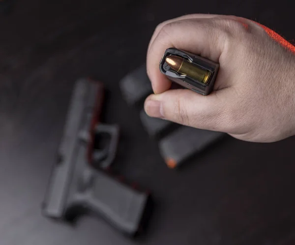 Reloading 9mm with gun in background