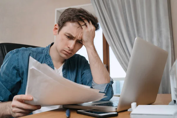 Unpappy Young Man Sitting Home Office Looking Thoughtful Papers Thinking — Stock Photo, Image