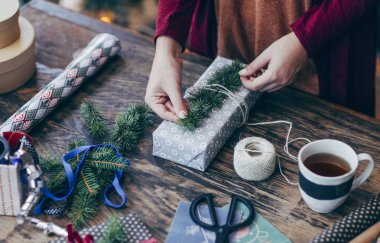 Noel hediyelerini paketleyen kadın.