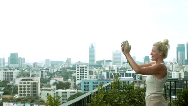 Blonde Woman Takes Photo on a Balcony — Stock Video