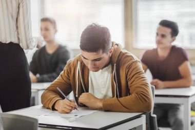 High School Student Doing an Exam clipart