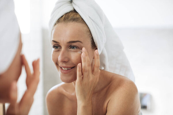 Woman Applying Creme on Face