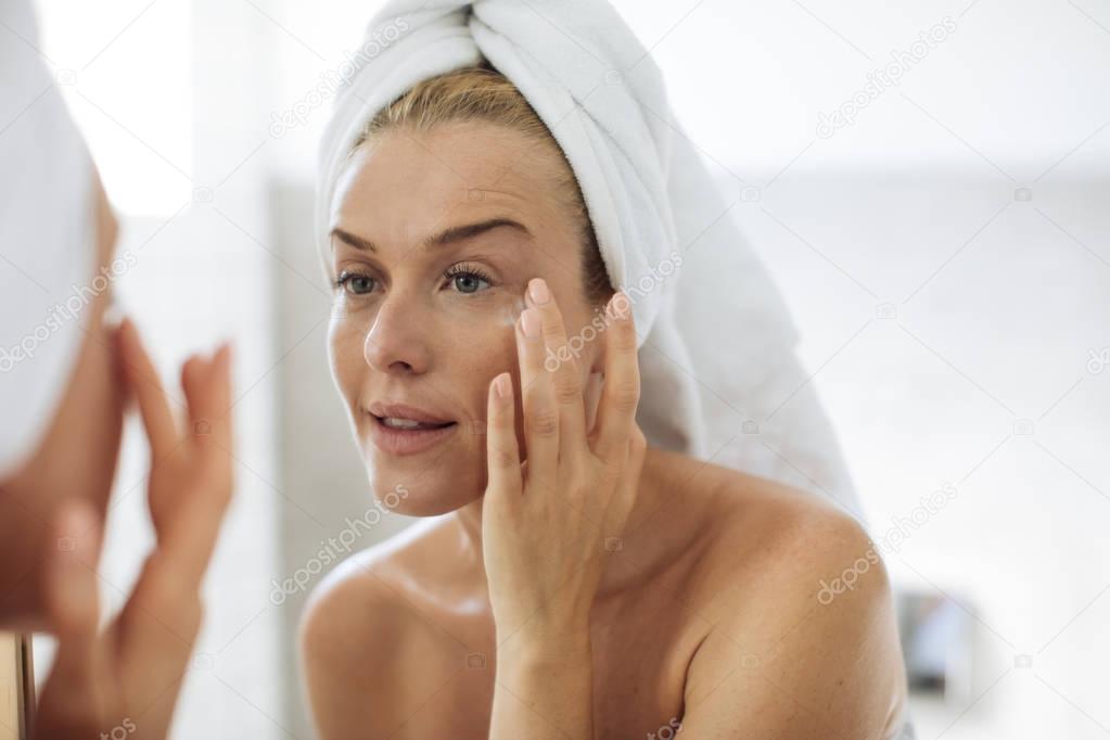 Woman Applying Moisturising Creme on Her Face