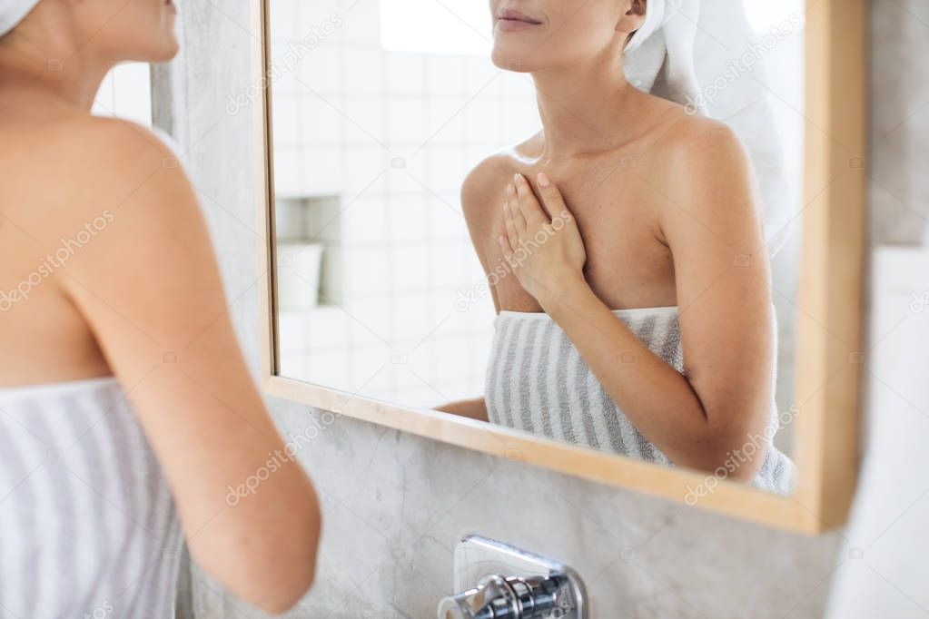 Woman Applying Skin Care Cosmetic