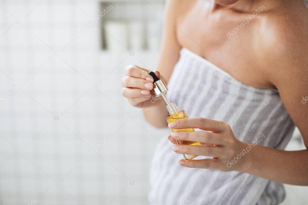Woman Holding Cosmetic Serum