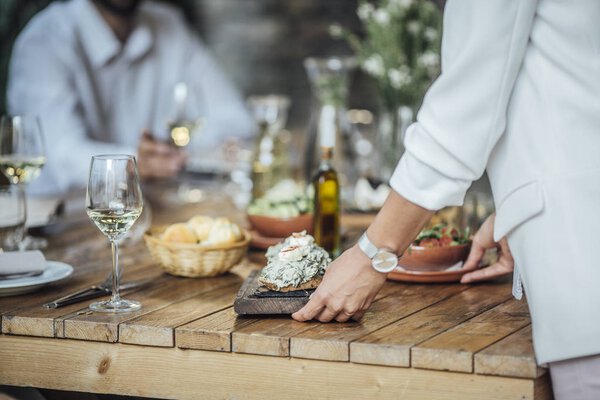 Woman Dinner Party Host Serving Food to Her Friends