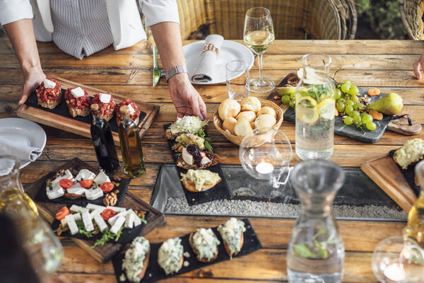 Woman Dinner Party Host Serving Food to Her Friends