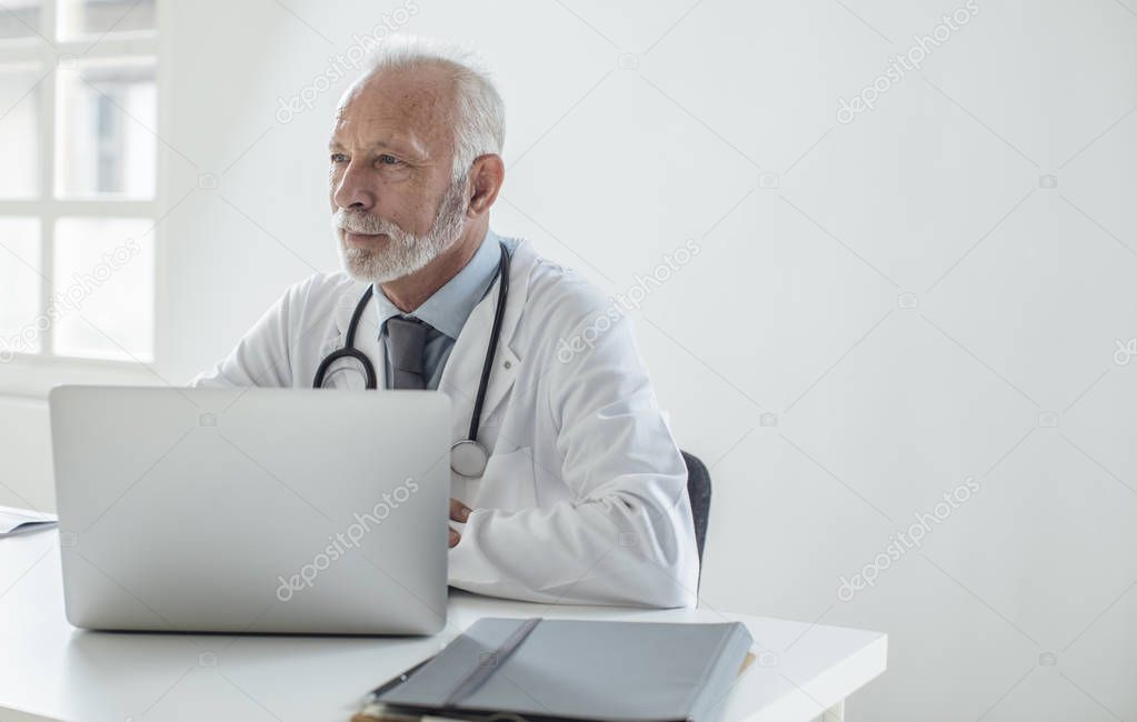 Physician Working at His Office