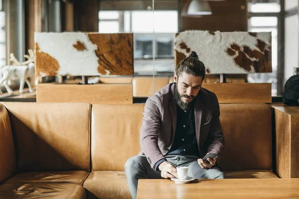 Businessman Sitting at Mountain Hotel Foyer