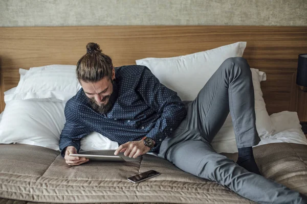 Handsome Caucasian Businessman Freelancer Lying Hotel Bed Using Tablet — Stock Photo, Image