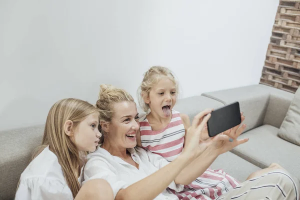 Mother and Children Using Cell Phone Camera Royalty Free Stock Images