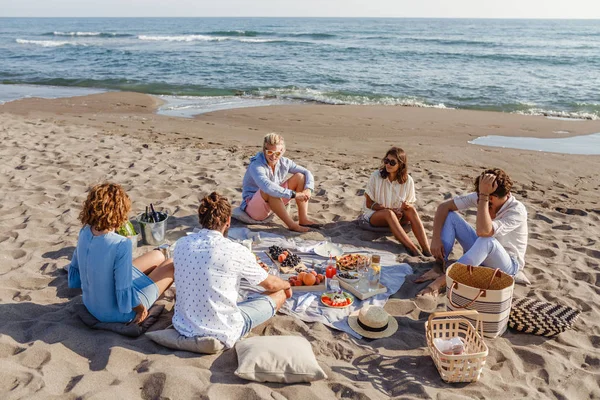 Φίλοι έχοντας πικ-νικ στην παραλία — Φωτογραφία Αρχείου