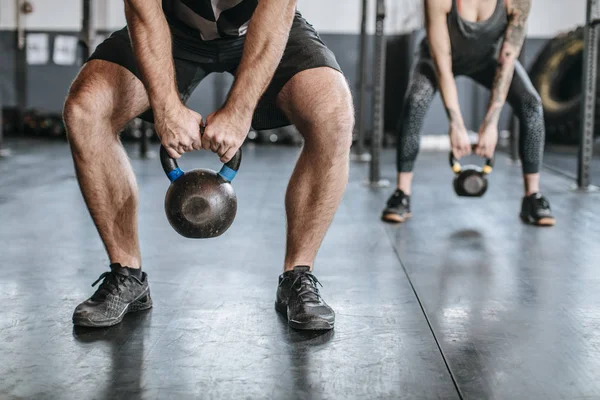 Deportistas y deportistas levantando pesas en el gimnasio —  Fotos de Stock