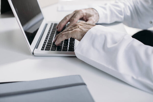 A Doctor Typing on Laptop