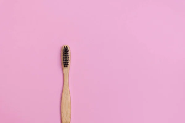 Top view of eco-friendly bamboo toothbrush on soft pink background — Stock Photo, Image