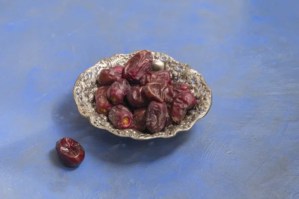 Ramadan fasting composition. Dried dates in a metallic plate — Stock Photo, Image