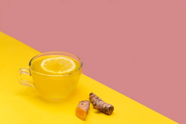 Cup of turmeric tea with lemon and ginger