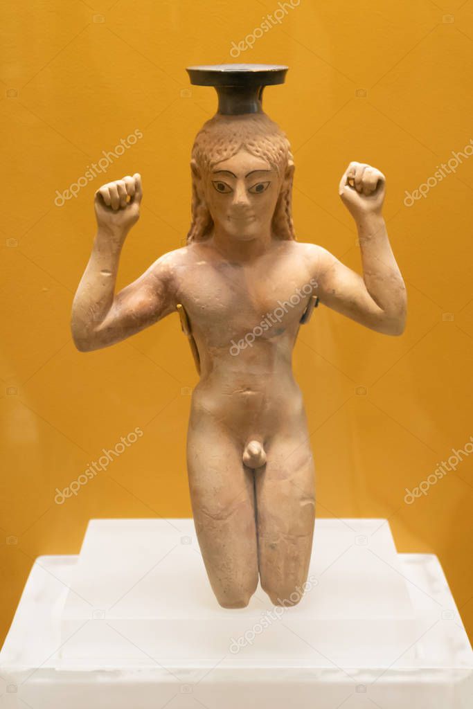 Perfume bottle in the form of a kneeling athlete binding a ribbo