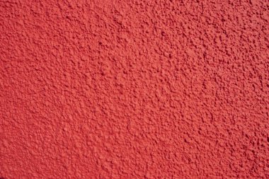 Güneşli bir günde kırmızı duvar arkaplanı 