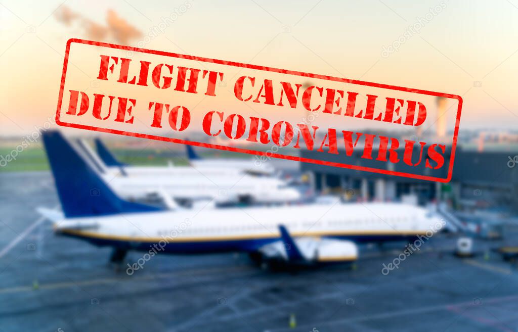 Flight cancelled. Defocused view of grounded passenger airplanes on empty and closed airfield or airport due to coronavirus or covid 19 pandemics