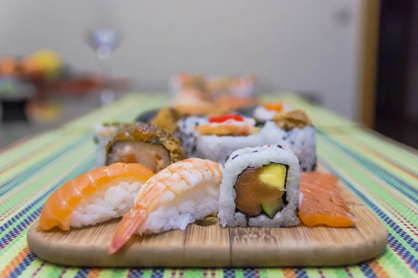Wooden board with assorted sushi — Stock Photo, Image