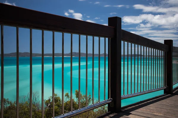 Handrail by a clear light blue seascape