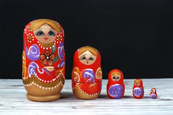 Russian matryoshka wooden dolls isolated on black