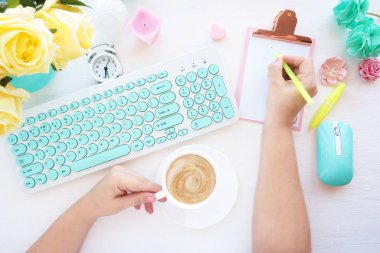 En iyi görüntü. Bir kadın panoya girer ve elinde bir bardak kapuçino tutar. Bir buket çiçekli ev hanımı.