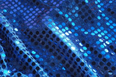 Düz olmayan parlak mavi kumaşın arkaplan ve dokusu pullarla