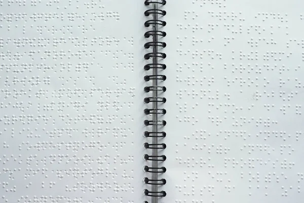 Braille font on paper. Close-up. Children's book