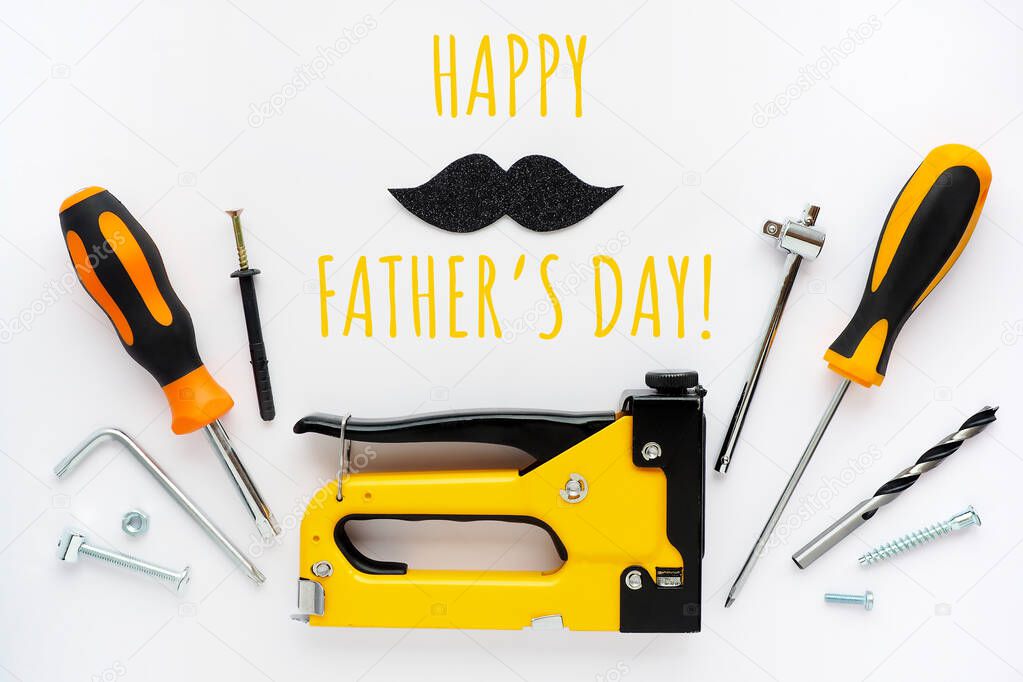 postcard of happy father's day. yellow lettering, black shiny mustache and tools for construction and repai