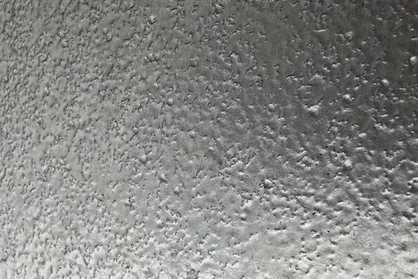 stainless steel surface covered with ice crust.