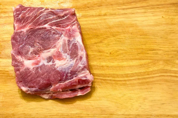 Slice of fresh pork on a wooden board. — Stock Photo, Image