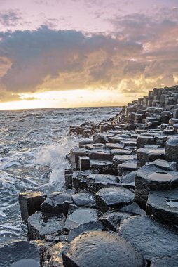 Sunset with the Giants Causeway in the foreground clipart