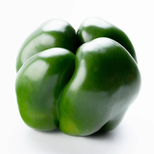 Single green bell pepper on a white surface — Stock Photo, Image