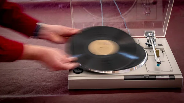 Motion of putting a new record on a record player