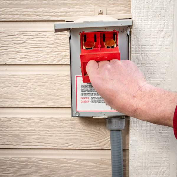Red fuse box is removed from a power box from a home utility