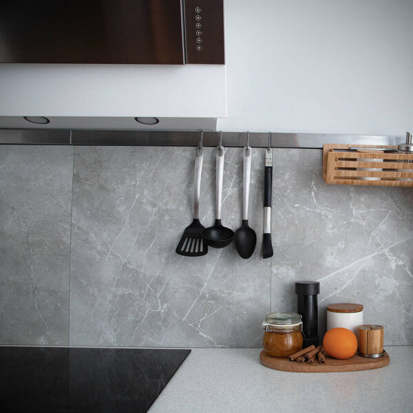 orange, cinnamon, and honey on a wooden board in a gray kitchen, cooking appliances