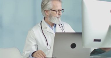 Ofisindeki doktor röntgen ve tomografi sonuçlarına bakıyor. 