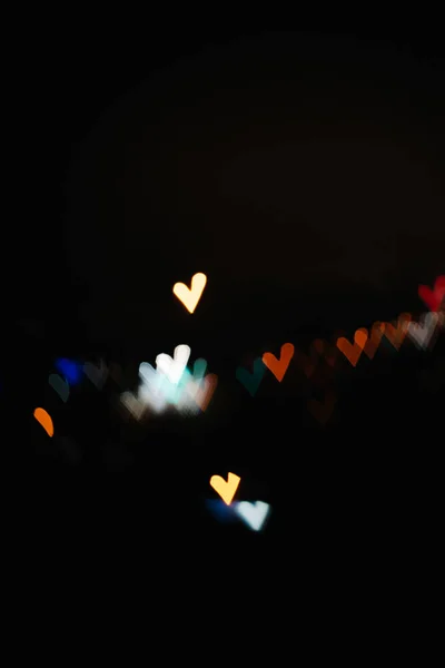 Boken colorful hearts from the lights of the night city — Stock Photo, Image