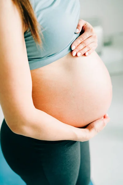 Una Joven Embarazada Ropa Deportiva Está Pie Sobre Una Esterilla — Foto de Stock