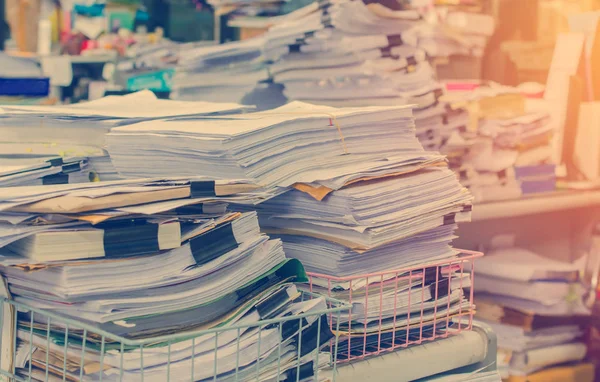 Pile of documents on desk stack up high waiting to be managed — Stock Photo, Image