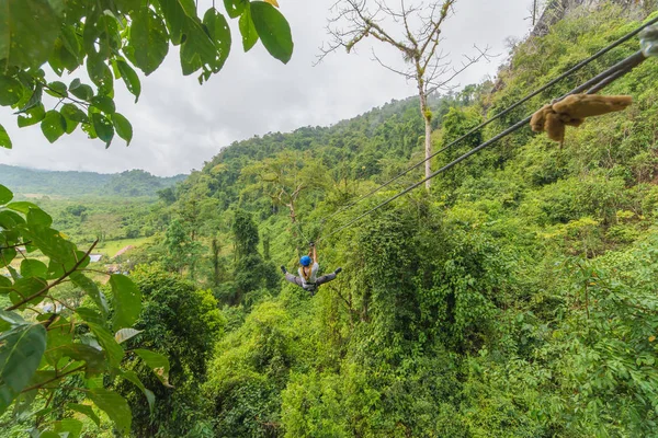 Man going on zipline adventure through the forest in Lao — Stock Photo, Image