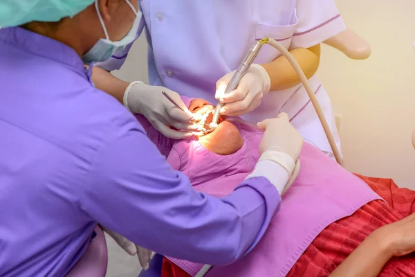 Dentist cleaning the teeth patient with ultrasonic tool — Stock Photo, Image